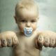 baby with knuckle tattoo